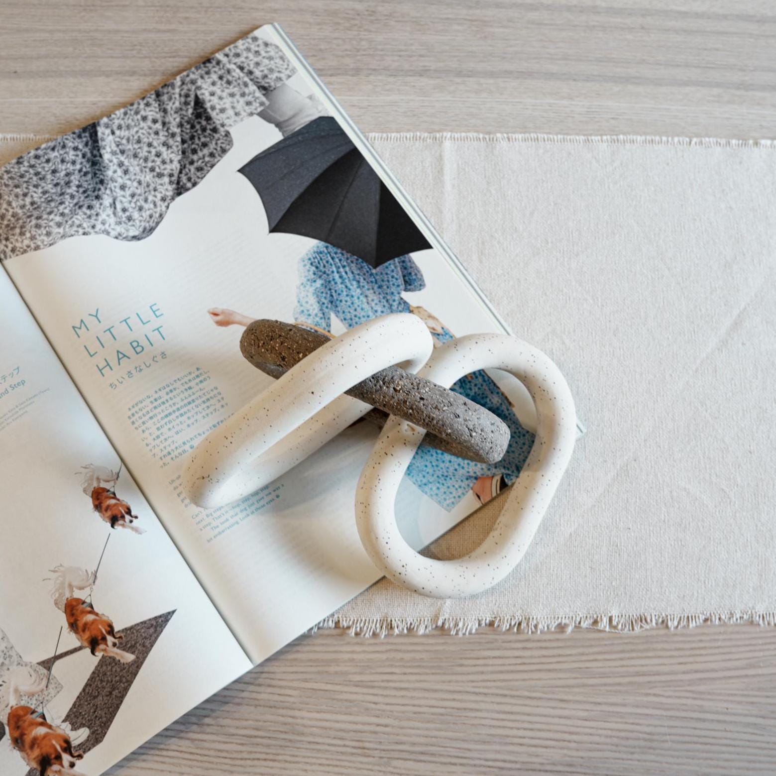 Minimalist decor scene featuring ceramic link sculpture