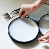 hand placing a dessert plate
