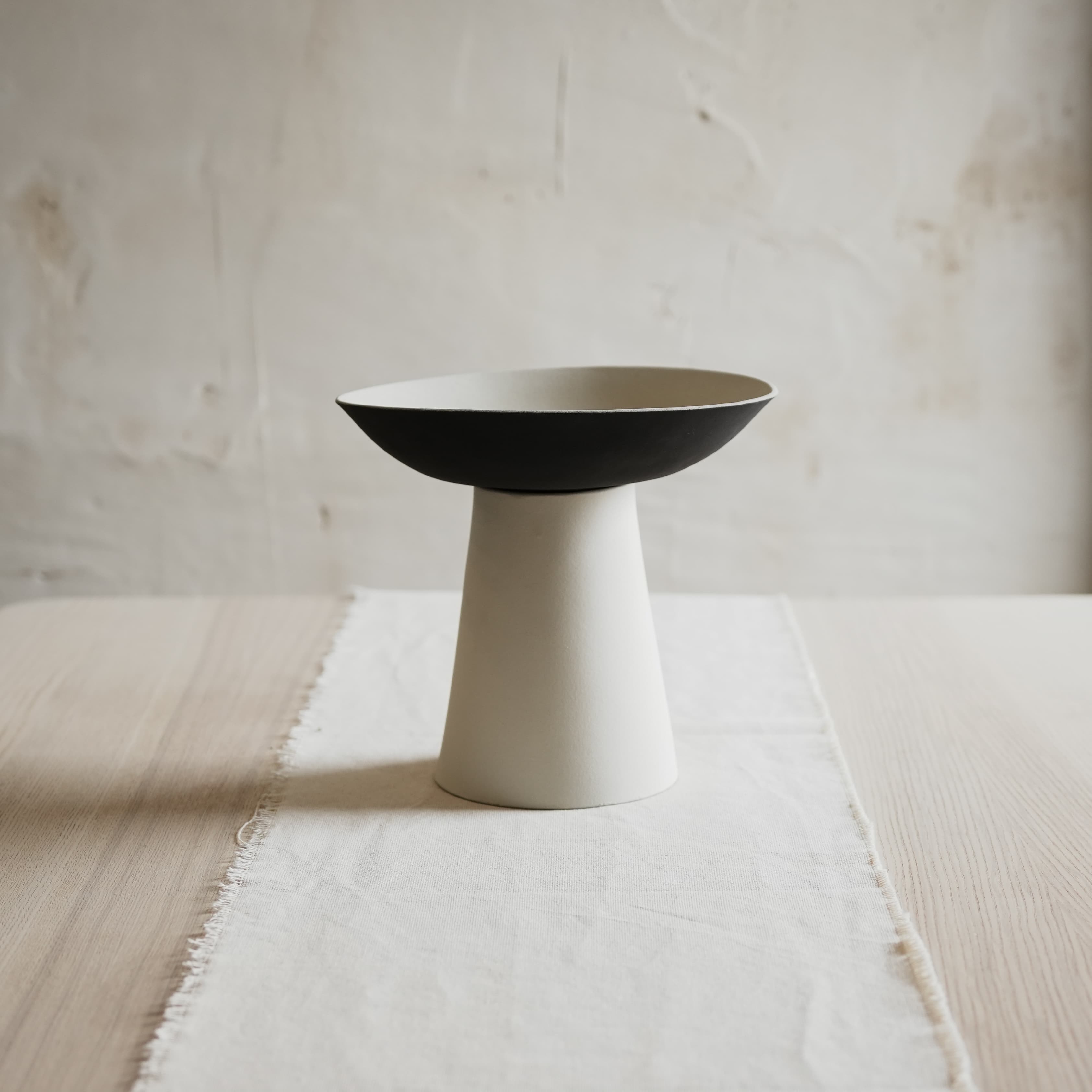 Handcrafted black and white ceramic bowl on stand – modern table centerpiece