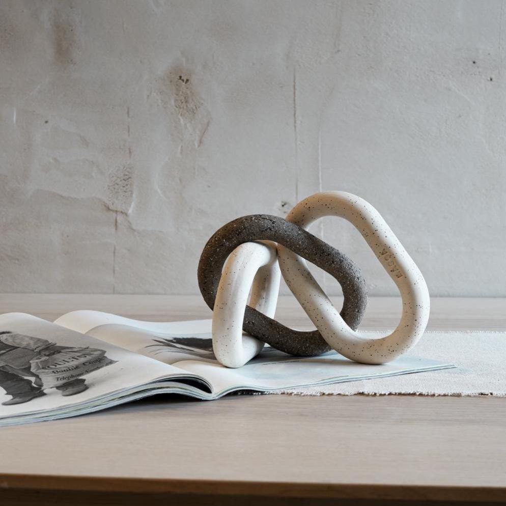 Minimalist ceramic chain displayed as tabletop art