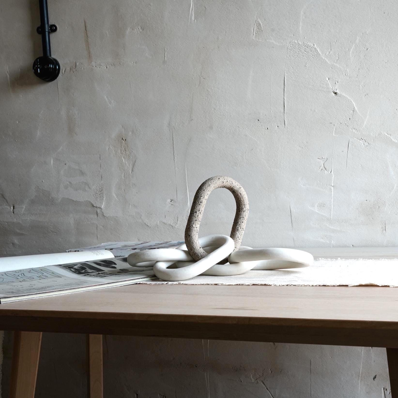 Modern porcelain chain sculpture displayed as tabletop ceramic decor