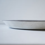detail image of white textured outer rim of large round tray decor