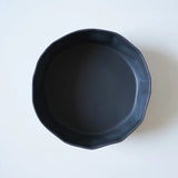 interior of black crumpled bowl