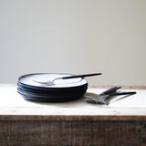 stack of handmade black and white plates