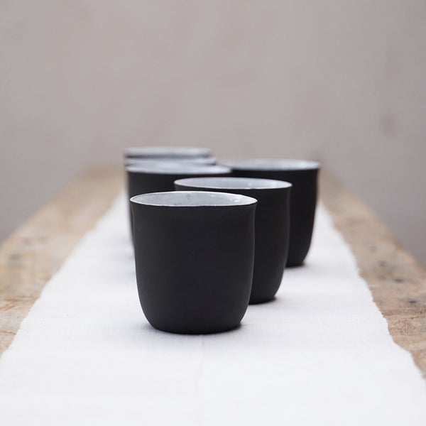 six black and white ceramic coffee cups