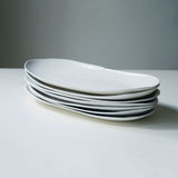 Stack of long white platters