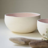 porcelain bowls with pink interior. Photographed from a profile view