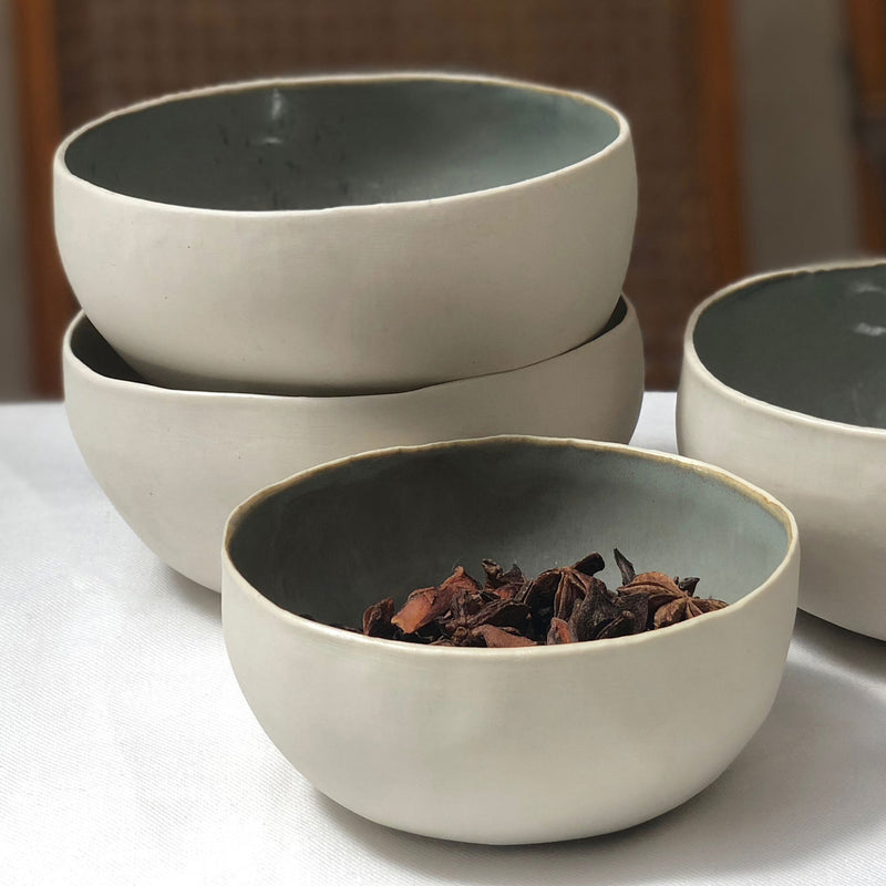 four porcelain coconut bowls with a mint color interior