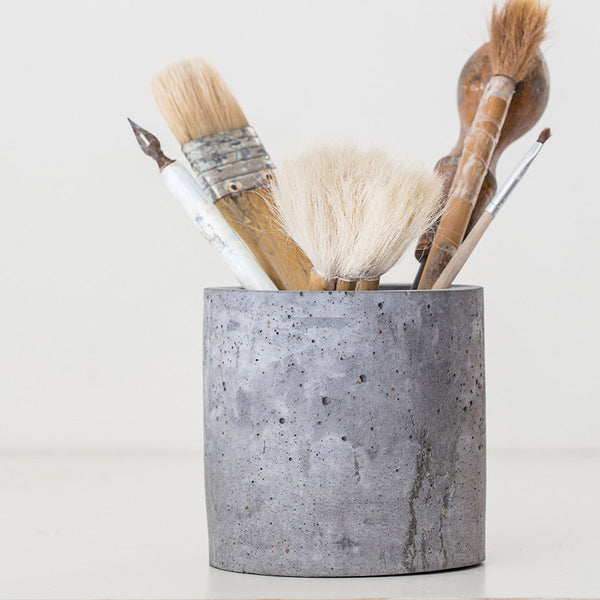 concrete vase with paint brushes